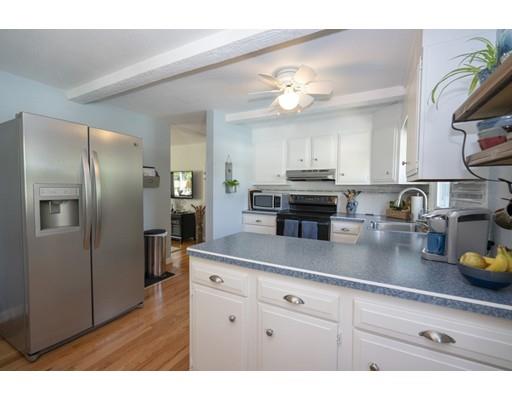 14 Rachel Street Springfield, MA 01129 - Photo 7 of 25 a kitchen with stainless steel appliances granite countertop a refrigerator a stove and a sink with wooden floor