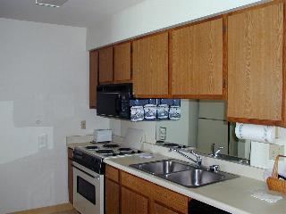 320 Papaloa Road, Unit 305 Kapaa, HI 96746 - Photo 6 of 8 a kitchen with a sink cabinets and stainless steel appliances