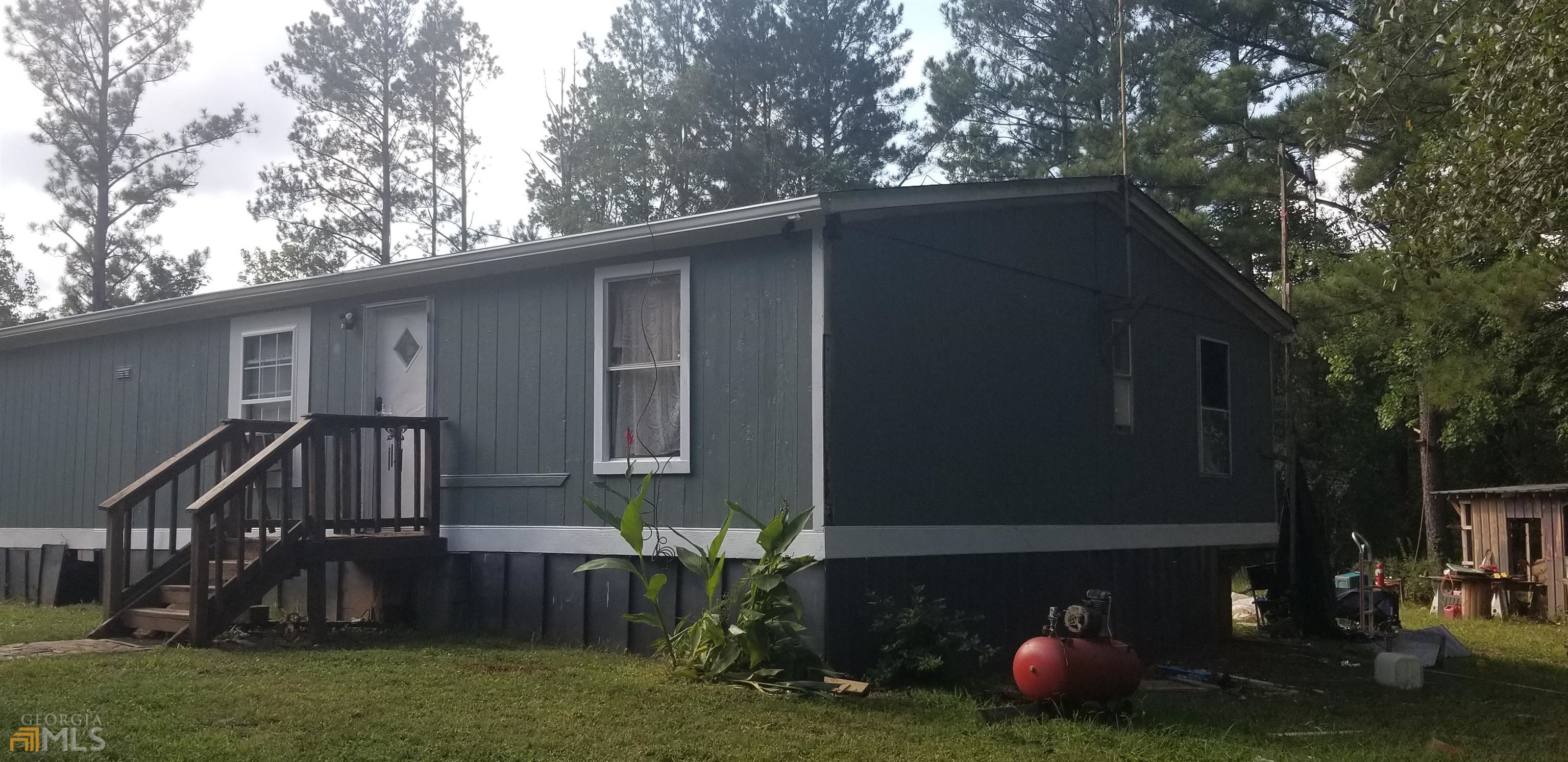 a view of house with backyard