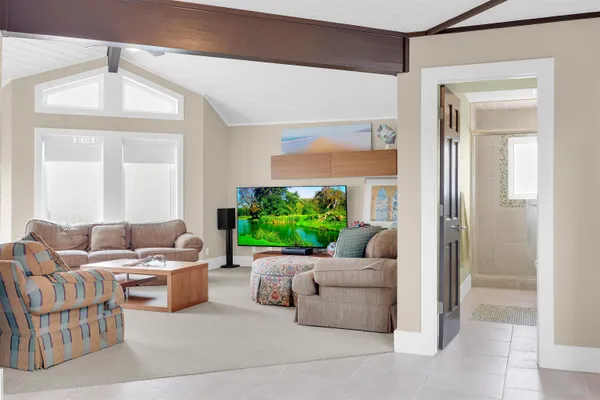 a living room with furniture and a floor to ceiling window