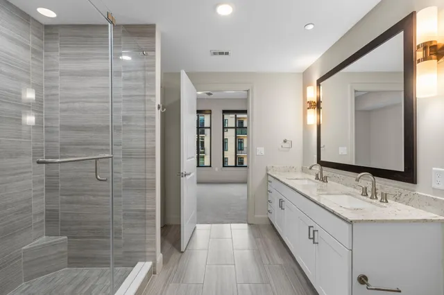 a bathroom with a double vanity sink and a mirror