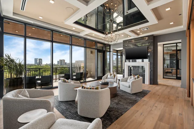 a living room with furniture a fireplace and a large window