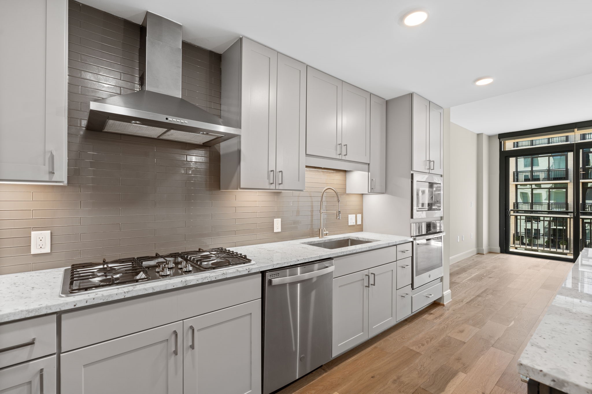 2511 Willowick Road, Unit 551 Houston, TX 77027 - Photo 6 of 45 a kitchen with stainless steel appliances a sink stove and cabinets