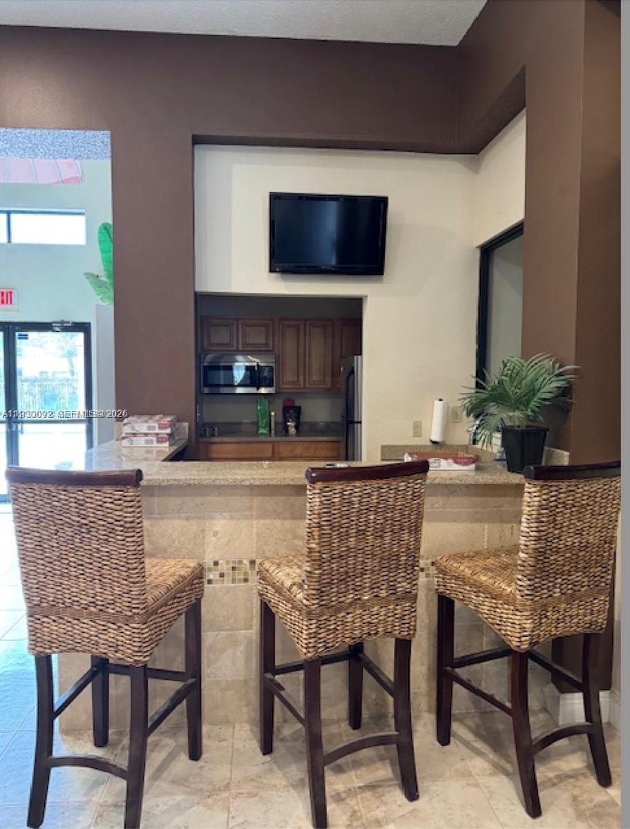 10501 Southwest 155th Court, Unit 1121 Miami, FL 33196 - Photo 18 of 28 a dining room with furniture and wooden floor