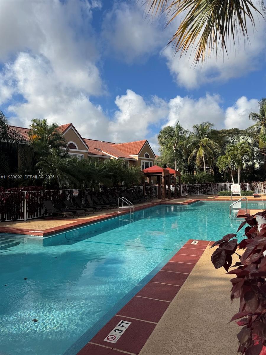 10501 Southwest 155th Court, Unit 1121 Miami, FL 33196 - Photo 19 of 28 a view of a garden and swimming pool