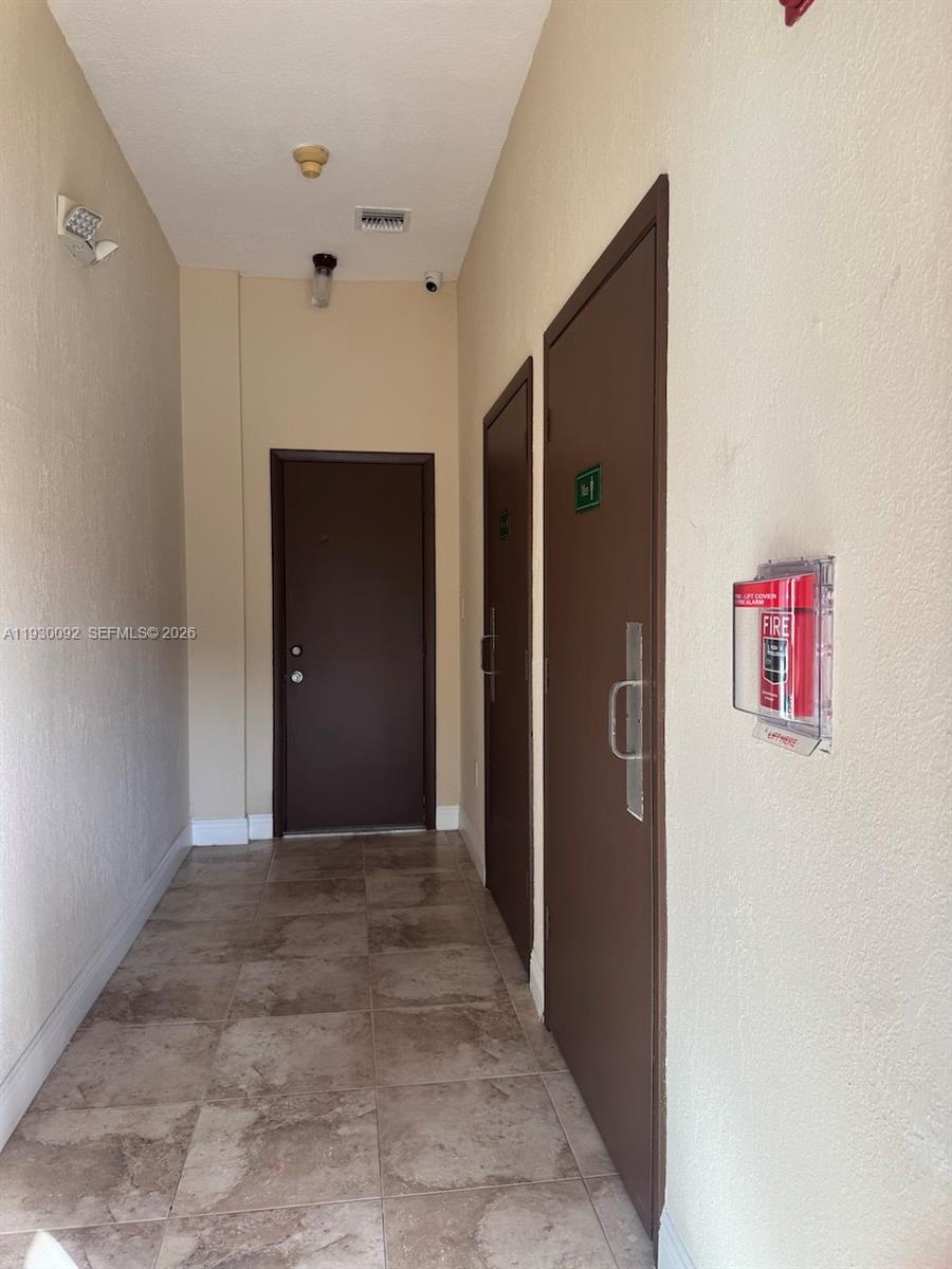 10501 Southwest 155th Court, Unit 1121 Miami, FL 33196 - Photo 20 of 28 a view of a hallway with wooden shelves