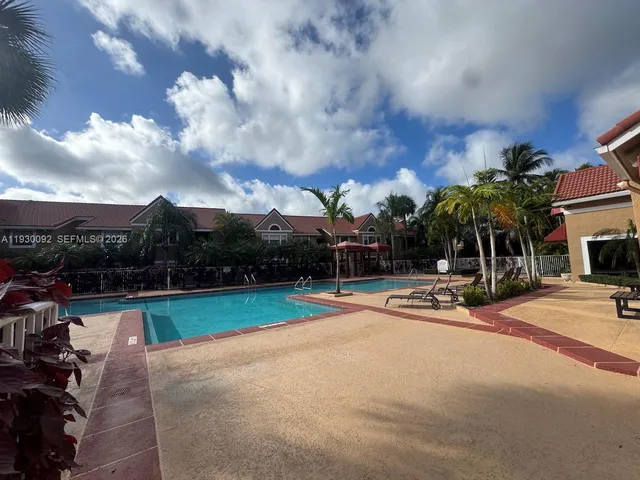 a bathroom with a granite countertop sink toilet mirror and a bathtub