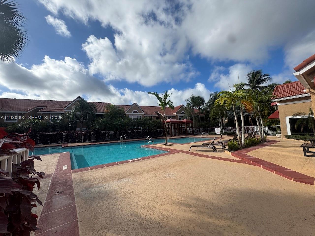 10501 Southwest 155th Court, Unit 1121 Miami, FL 33196 - Photo 21 of 28 a view of a patio with swimming pool and furniture
