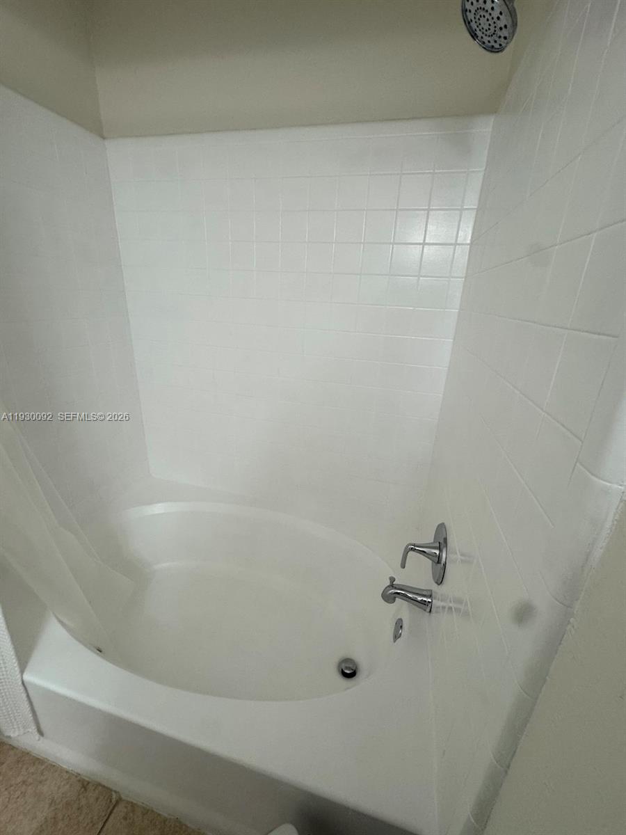 10501 Southwest 155th Court, Unit 1121 Miami, FL 33196 - Photo 23 of 28 a bathroom with a bathtub