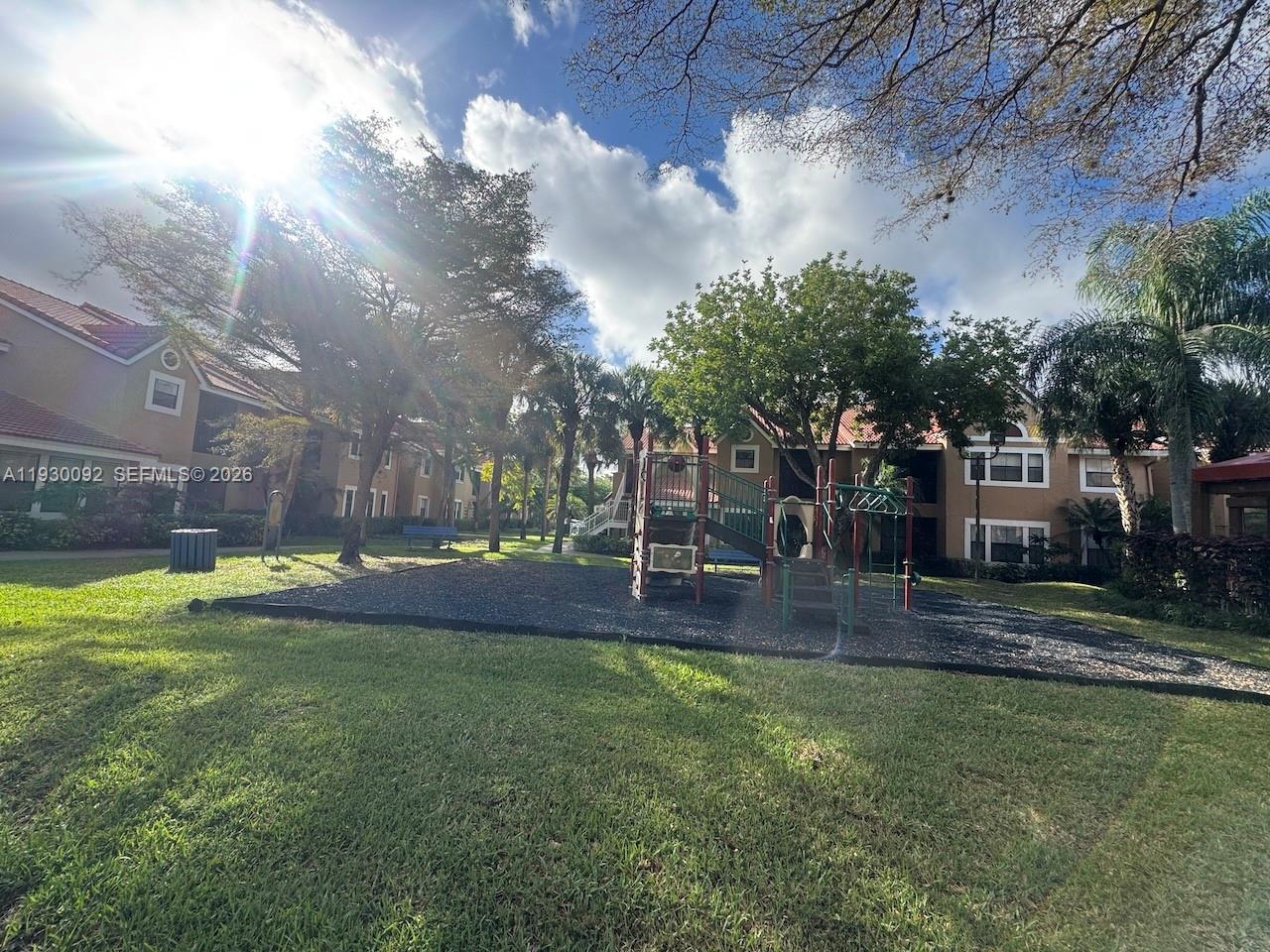 10501 Southwest 155th Court, Unit 1121 Miami, FL 33196 - Photo 28 of 28 a view of a swimming pool with an outdoor space and seating area