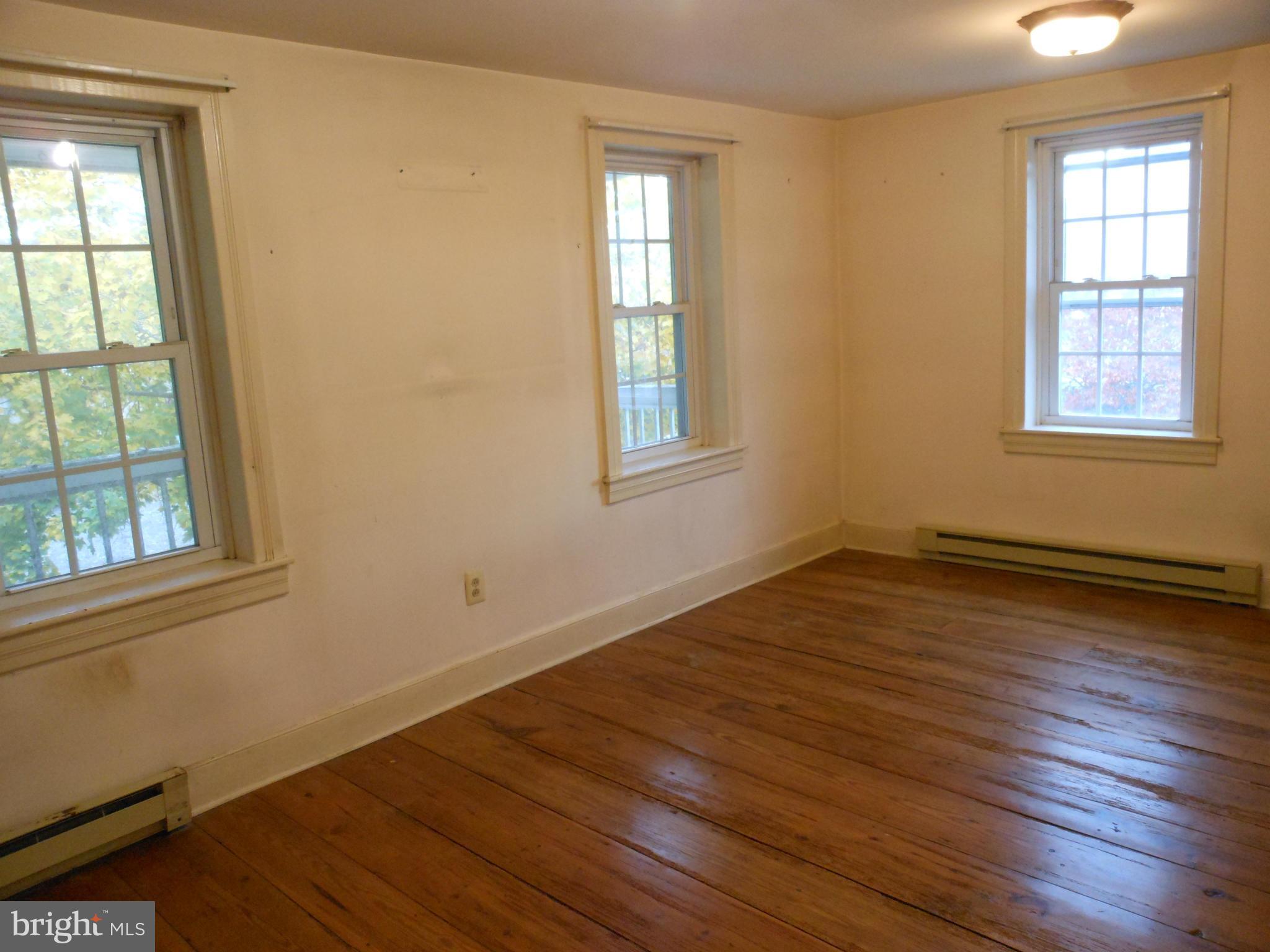 21715 Middletown Road Freeland, MD 21053 - Photo 3 of 30 an empty room with wooden floor and windows
