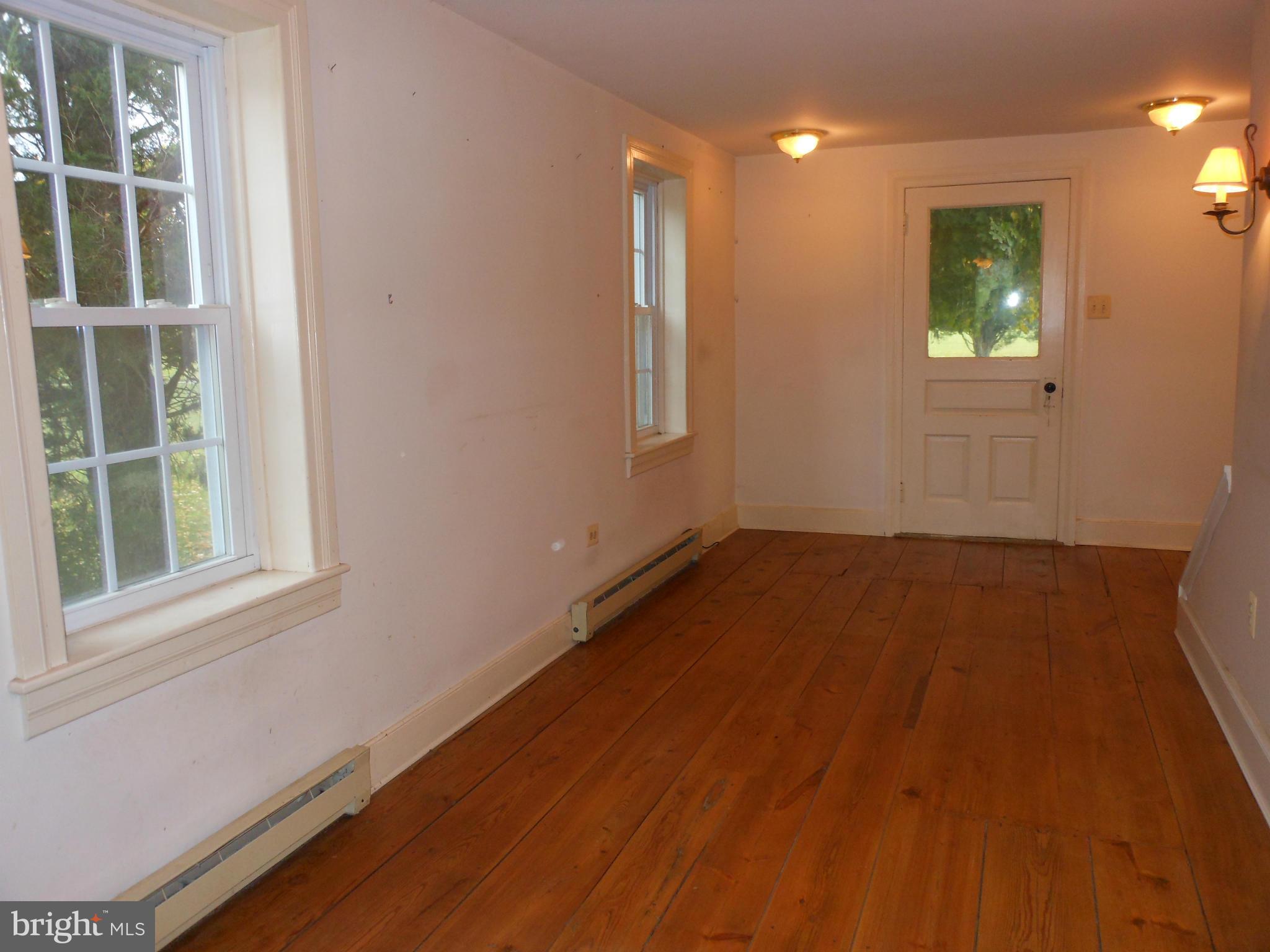 21715 Middletown Road Freeland, MD 21053 - Photo 5 of 30 an empty room with wooden floor and windows
