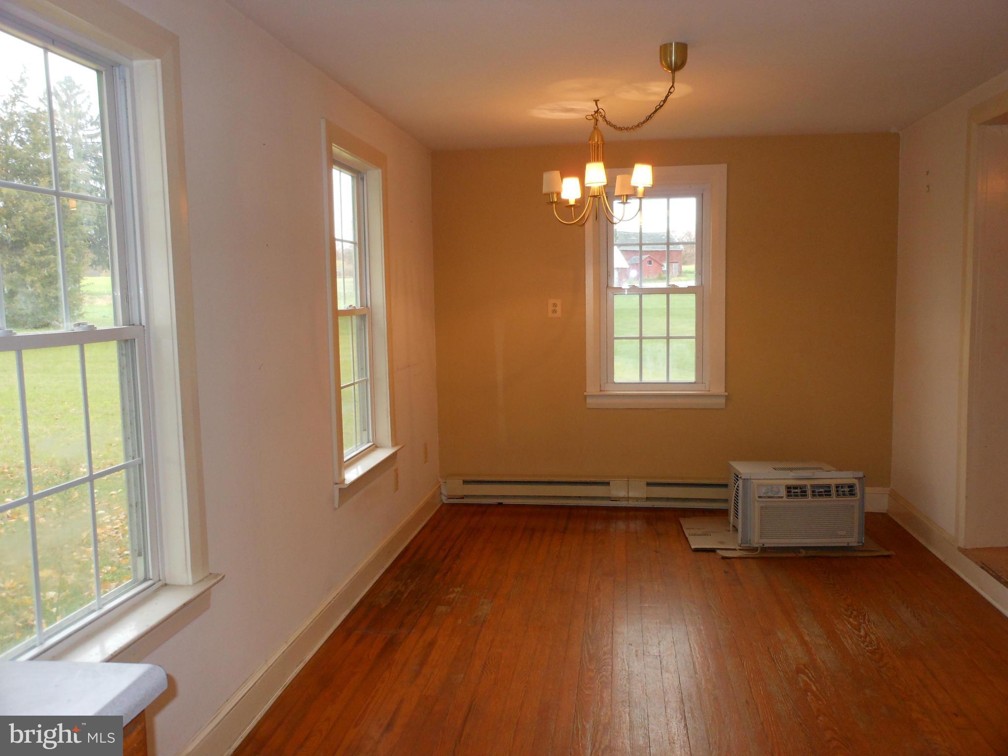 21715 Middletown Road Freeland, MD 21053 - Photo 7 of 30 an empty room with wooden floor and windows