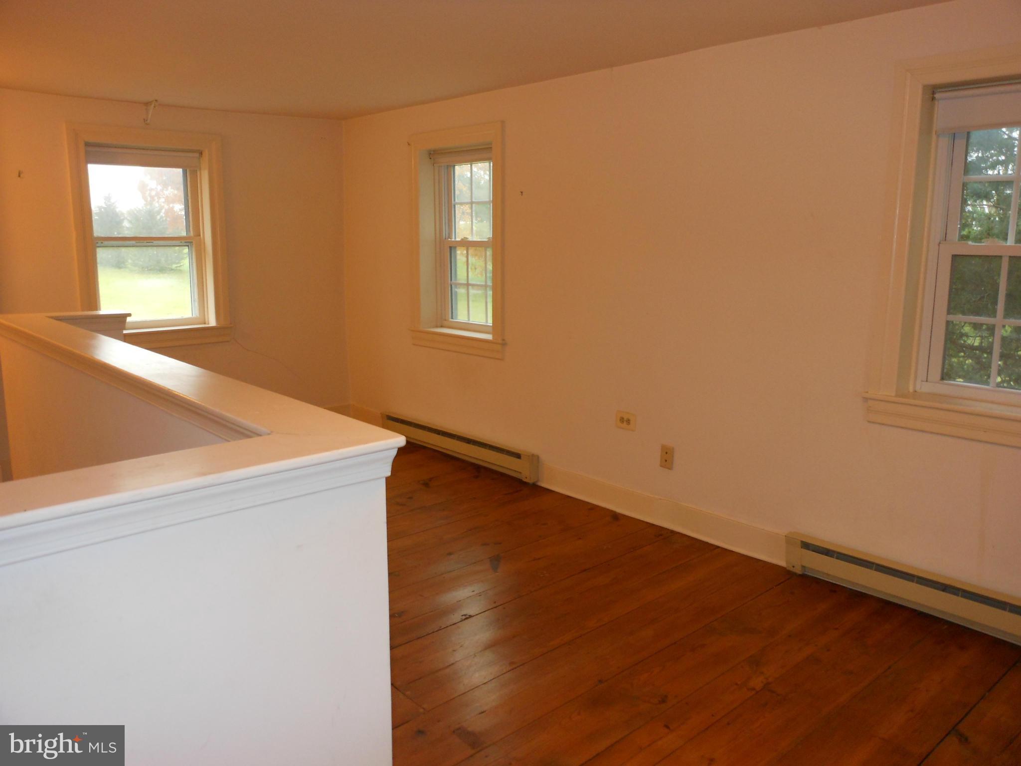 21715 Middletown Road Freeland, MD 21053 - Photo 8 of 30 an empty room with wooden floor and windows