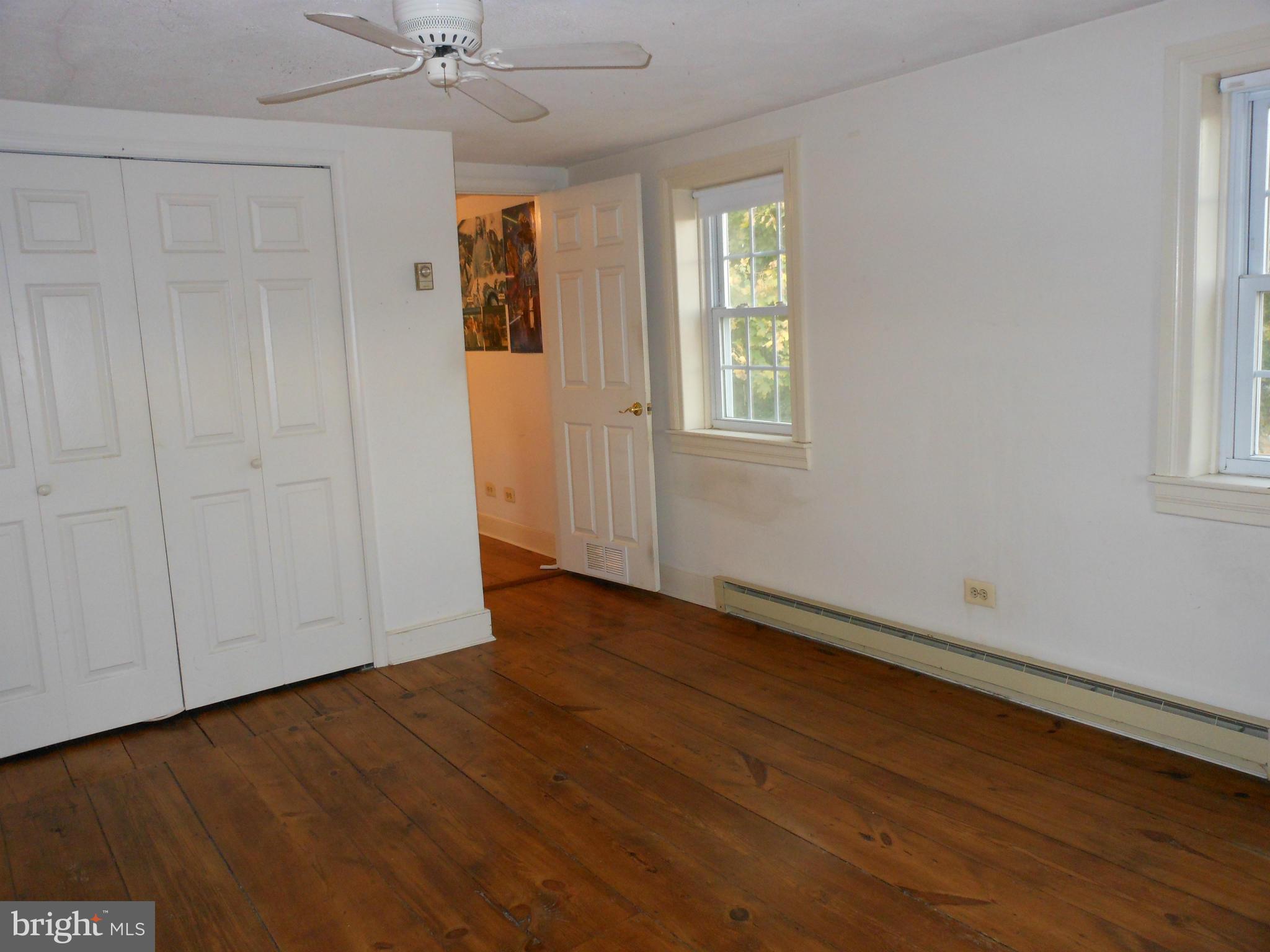 21715 Middletown Road Freeland, MD 21053 - Photo 10 of 30 an empty room with wooden floor cabinet and windows
