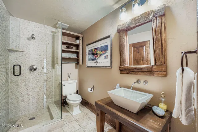 a bathroom with a sink toilet and shower