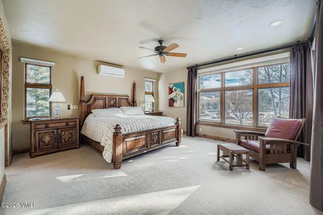 a bedroom with a bed and a lounge chair