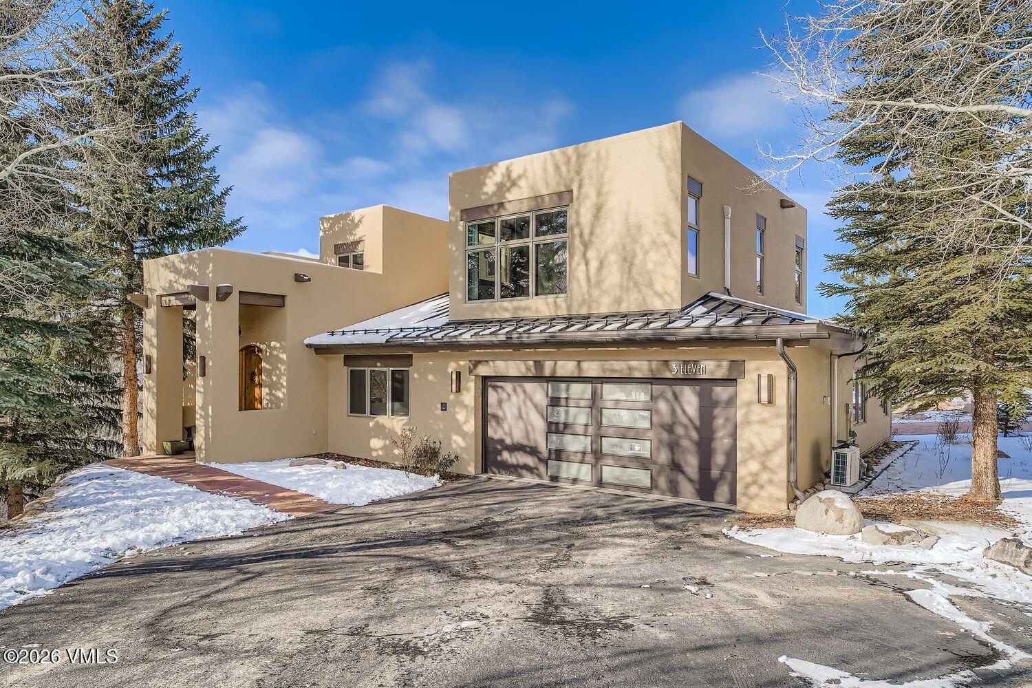 311 Foal Drive Edwards, CO 81632 - Photo 2 of 29 a view of a white house with a large tree and wooden fence