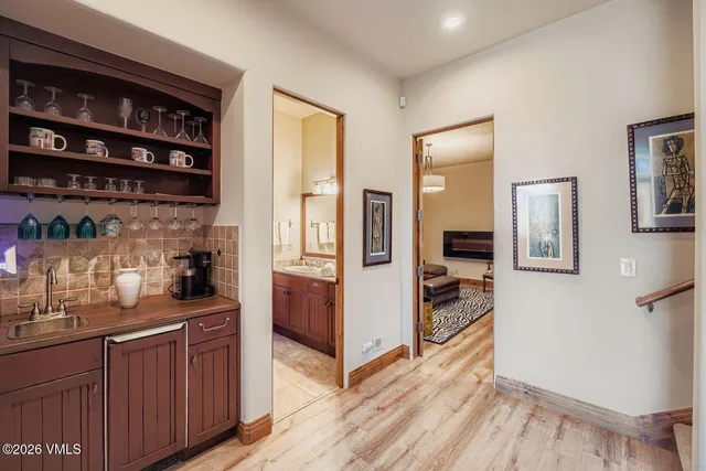 a kitchen with stainless steel appliances granite countertop a refrigerator and a wooden cabinets