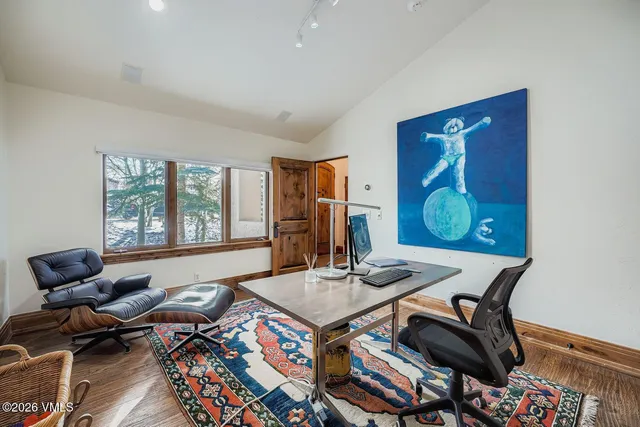 a living room with furniture and floor to ceiling window