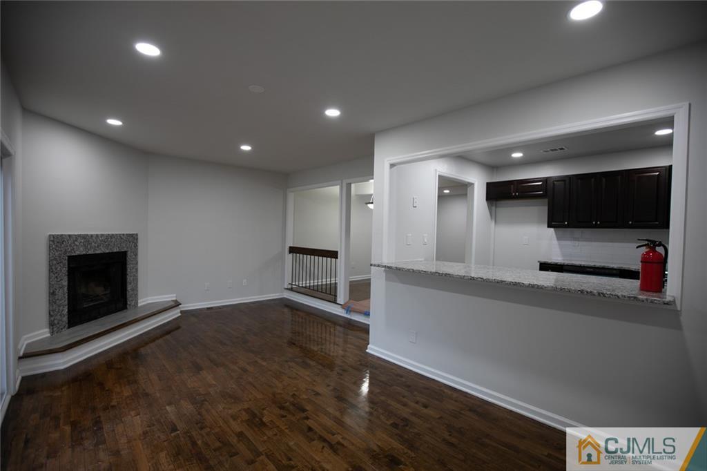 3402 Hana Road Edison, NJ 08817 - Photo 13 of 17 a view of a big room with wooden floor fire place and windows