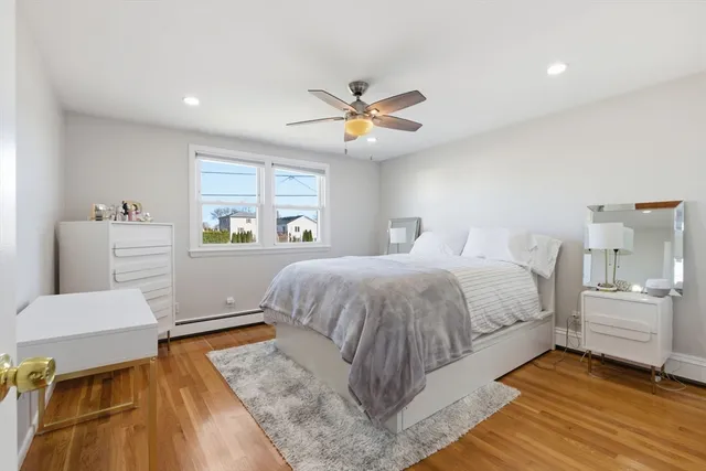 a spacious bedroom with a bed and a window