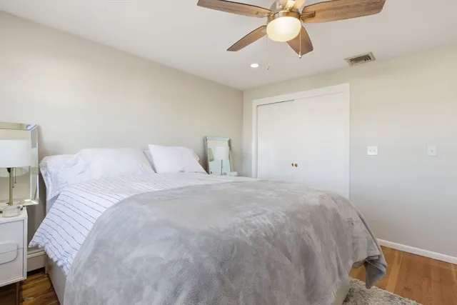 a bedroom with a bed and a ceiling fan