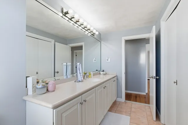 a bathroom with a sink a vanity and a mirror