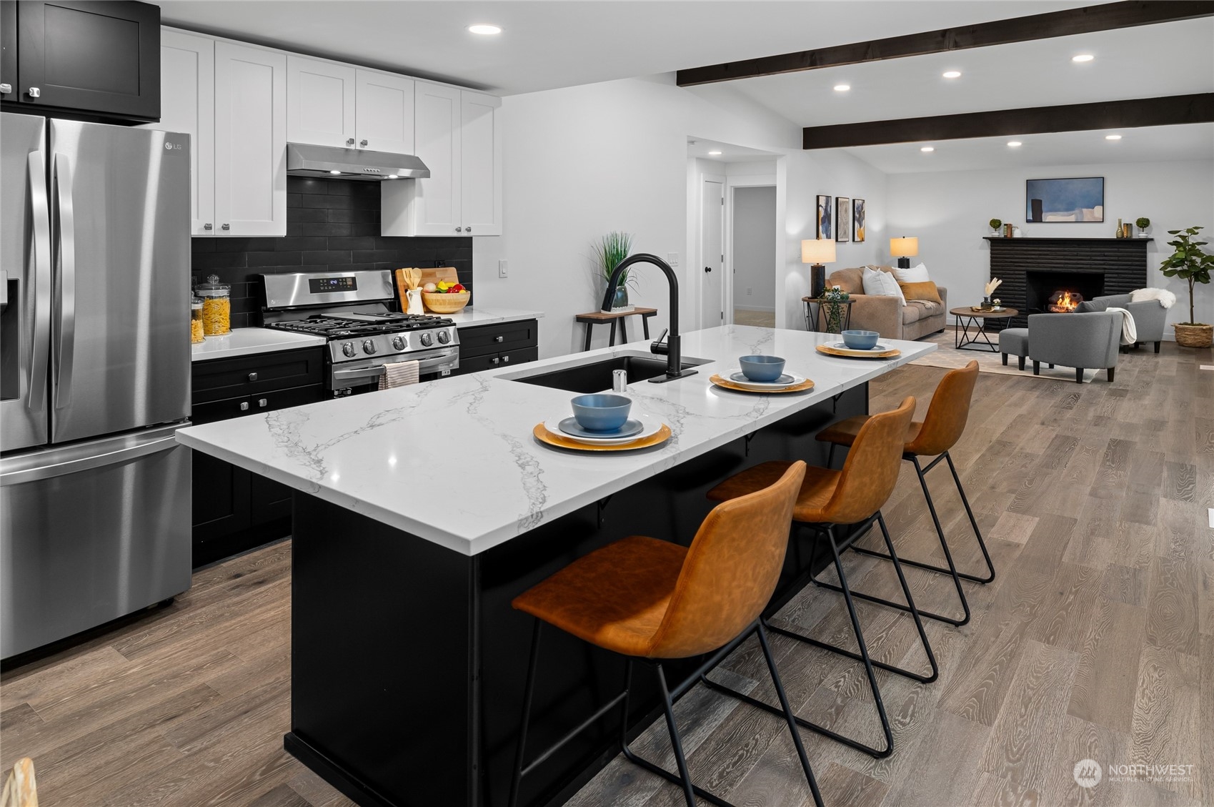 815 Rowell Street Steilacoom, WA 98388 - Photo 6 of 34 a kitchen with stainless steel appliances a table chairs refrigerator and microwave