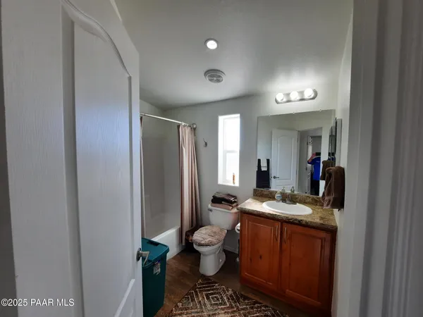 a bathroom with a shower and a mirror
