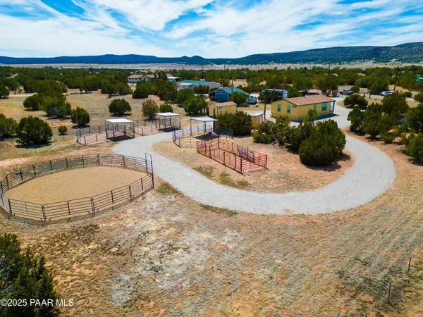 a living room with furniture a clock on wall and a window