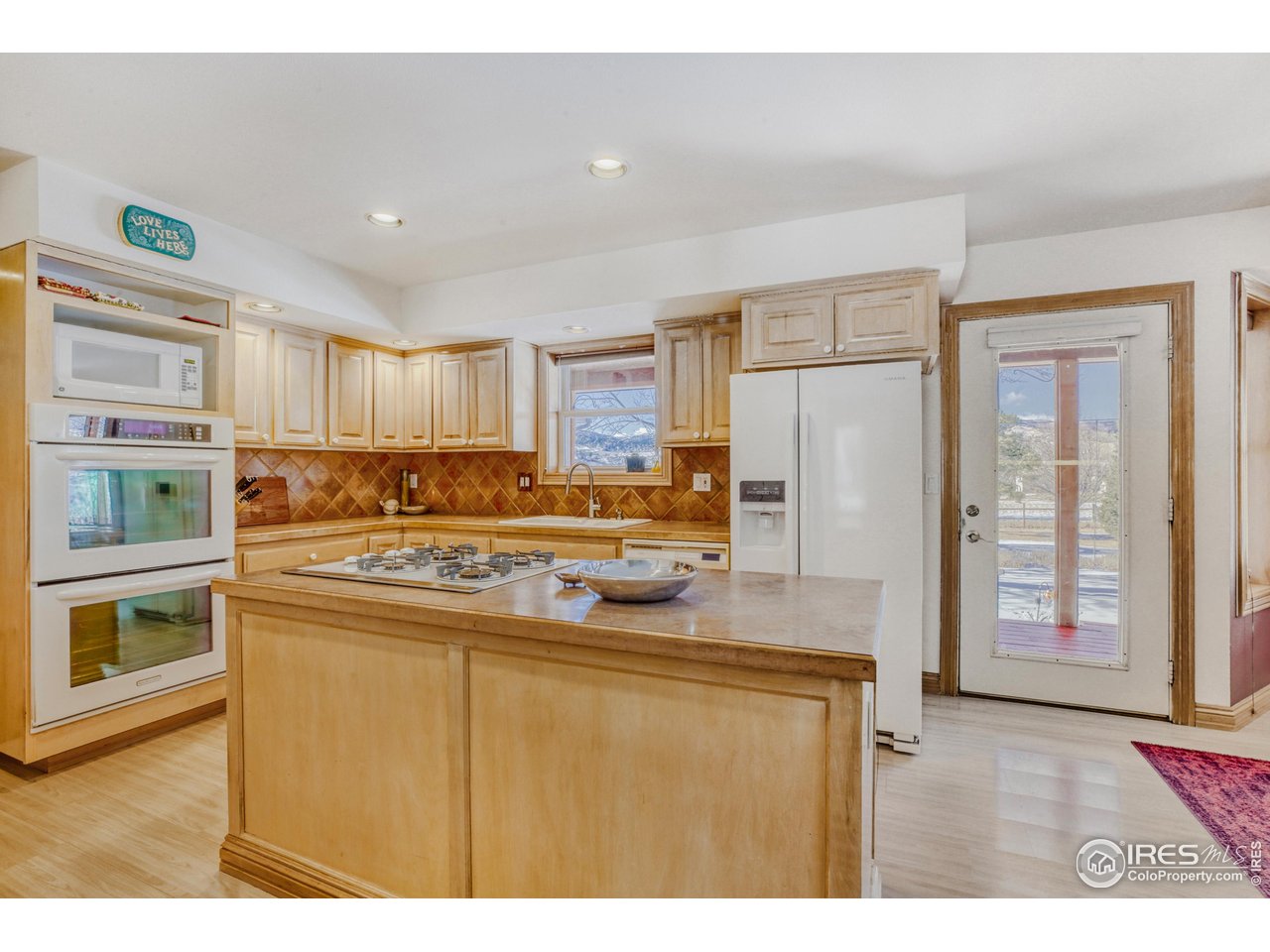 3617 Glade Road Loveland, CO 80538 - Photo 11 of 50 Kitchen and patio door to Rear Porch
