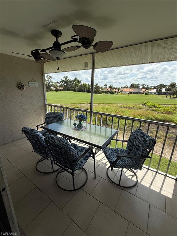760 Augusta Boulevard, Unit D204 Naples, FL 34113 - Photo 15 of 32 a living room with furniture and a floor to ceiling window