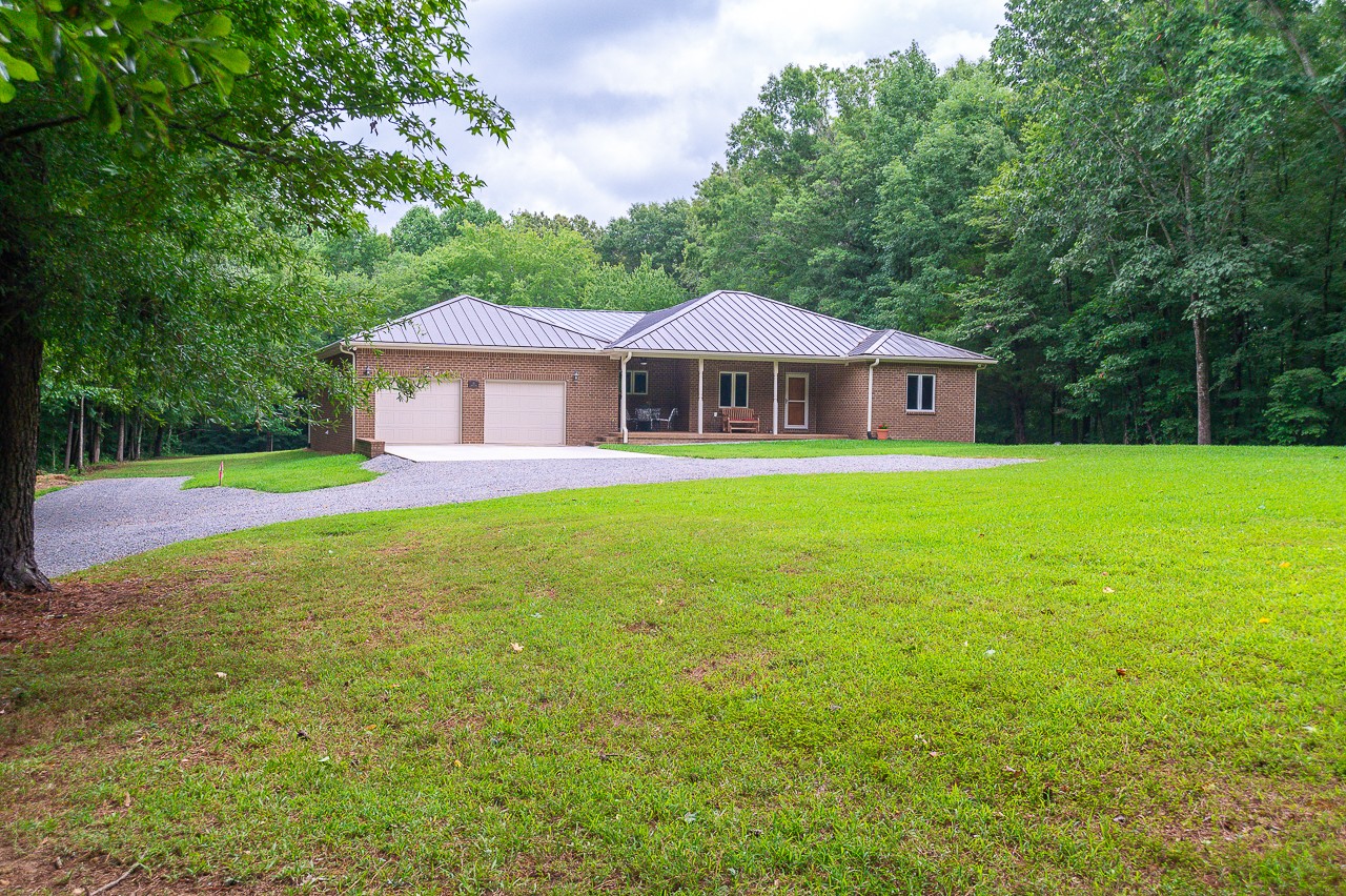 41 Arnold Road Flintville, TN 37335 - Photo 1 of 41 a white house with a big yard plants and large trees