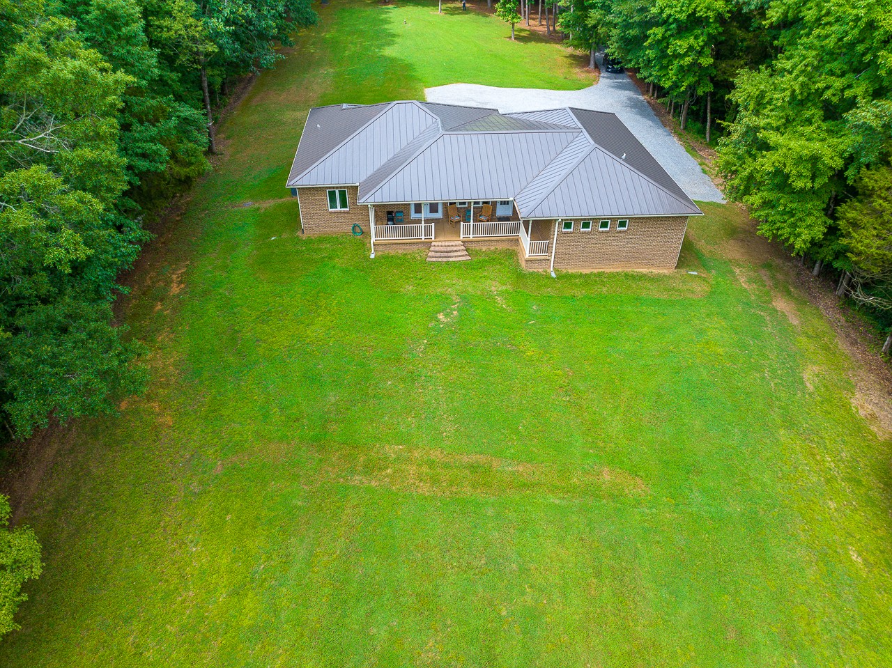 41 Arnold Road Flintville, TN 37335 - Photo 6 of 41 a view of a big house with a big yard and large trees