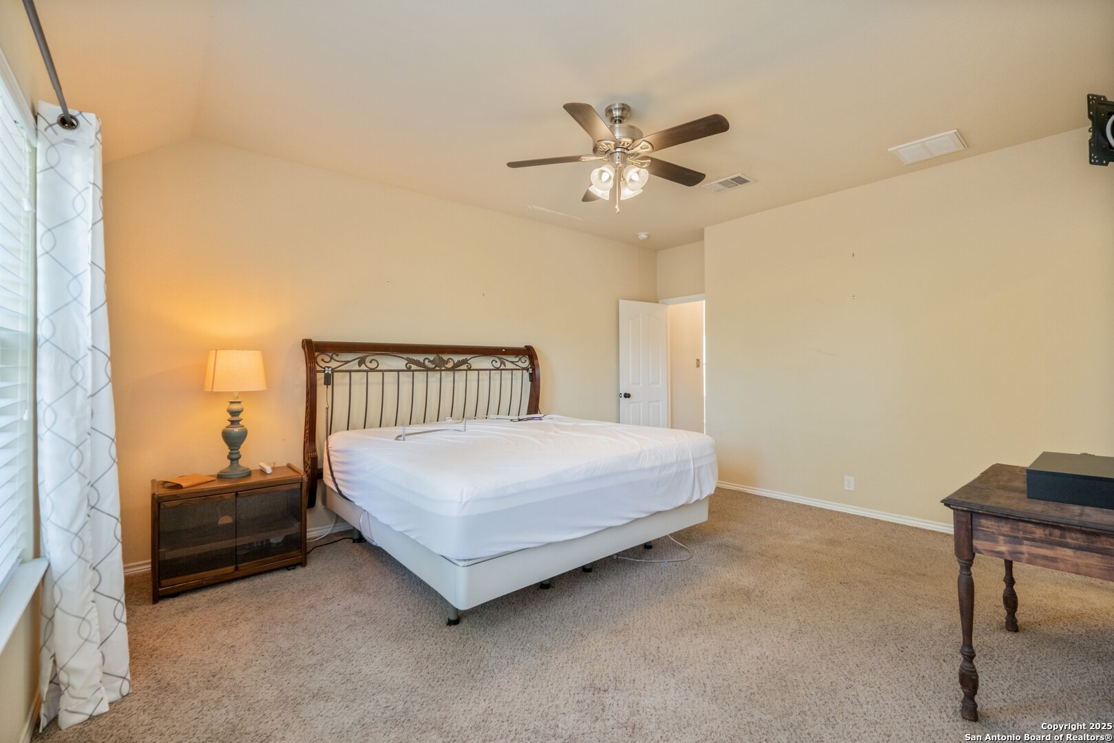 206 Club View West Seguin, TX 78155 - Photo 14 of 36 a bedroom with a bed and a chandelier
