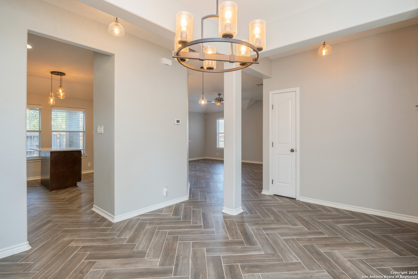 206 Club View West Seguin, TX 78155 - Photo 6 of 36 a view of a hallway with wooden floor and a chandelier