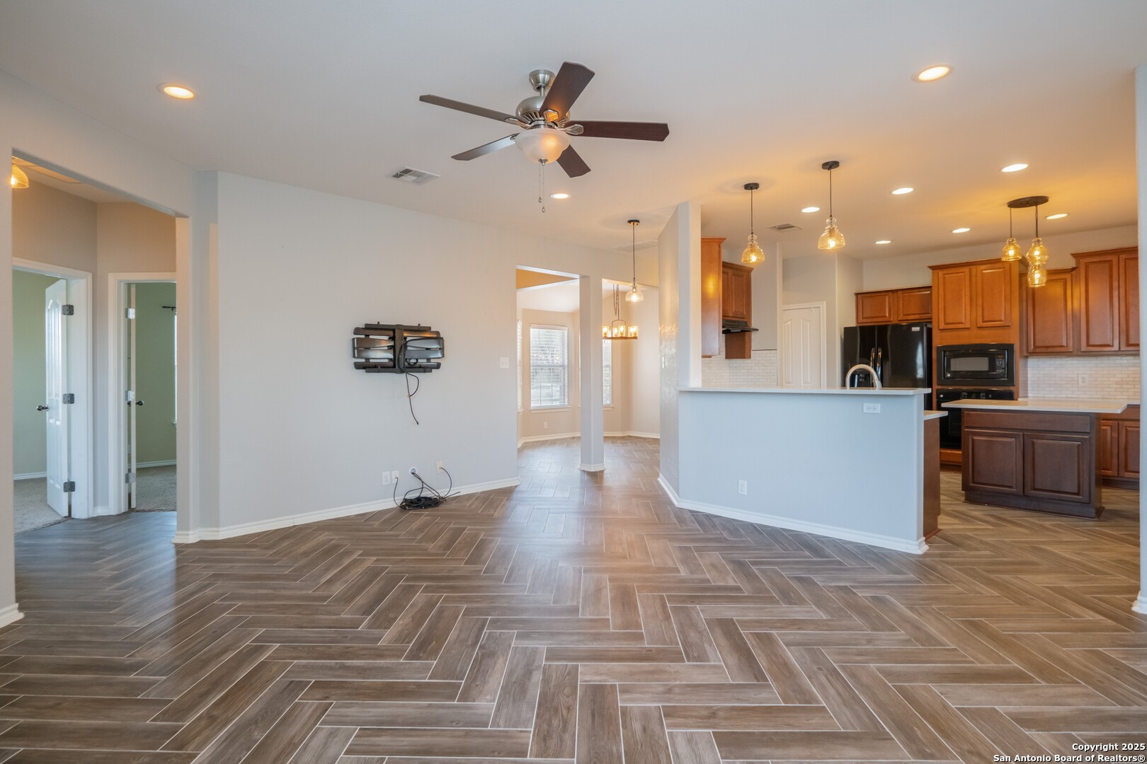 206 Club View West Seguin, TX 78155 - Photo 9 of 36 a view of a kitchen with kitchen island a stove a refrigerator cabinets and living room view