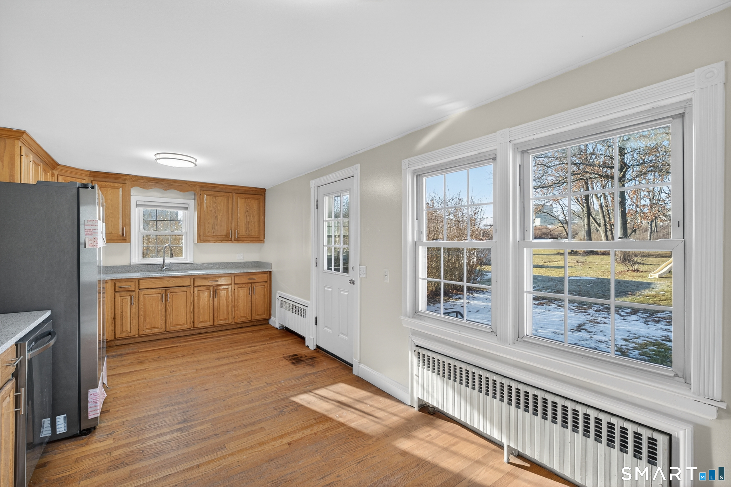 195 Middletown Avenue Wethersfield, CT 06109 - Photo 13 of 35 a kitchen with stainless steel appliances wooden floor and a refrigerator