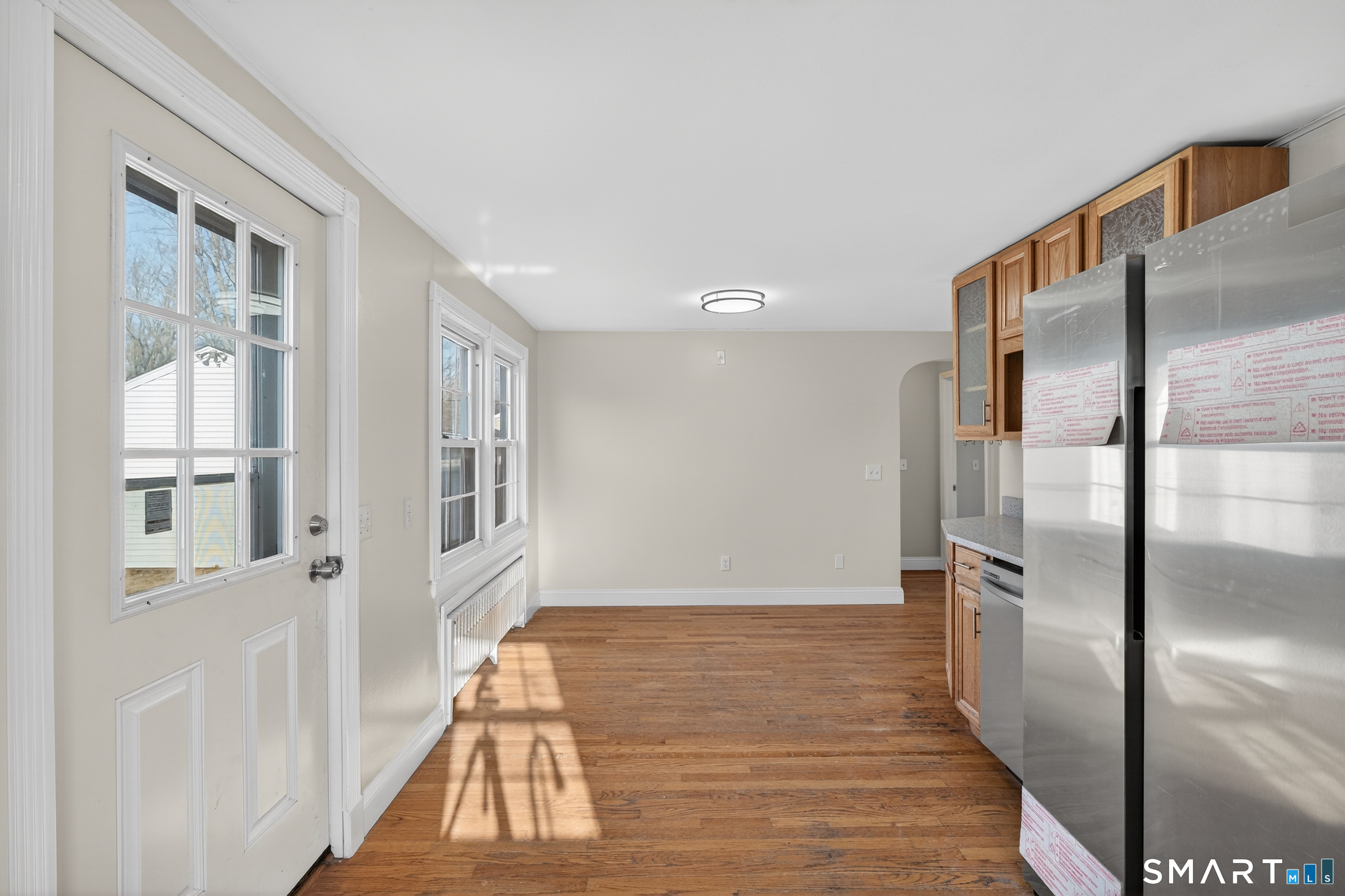 195 Middletown Avenue Wethersfield, CT 06109 - Photo 14 of 35 a view of a refrigerator in kitchen and wooden floor