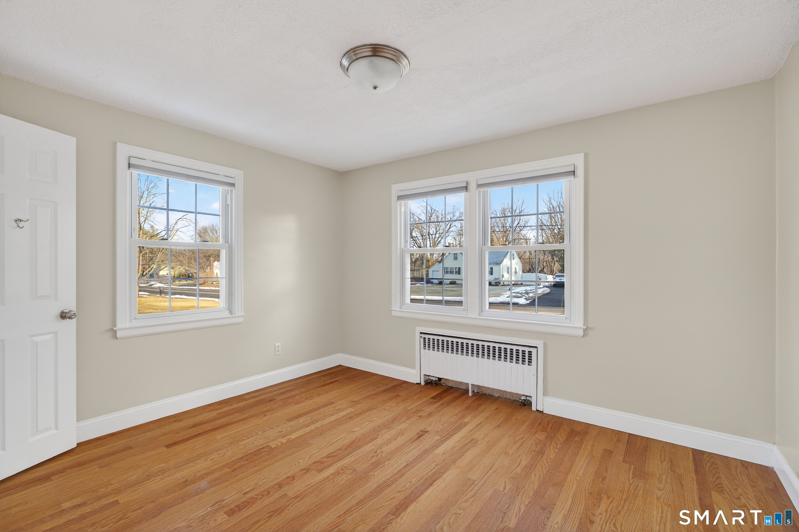 195 Middletown Avenue Wethersfield, CT 06109 - Photo 15 of 35 a view of an empty room with wooden floor and a window