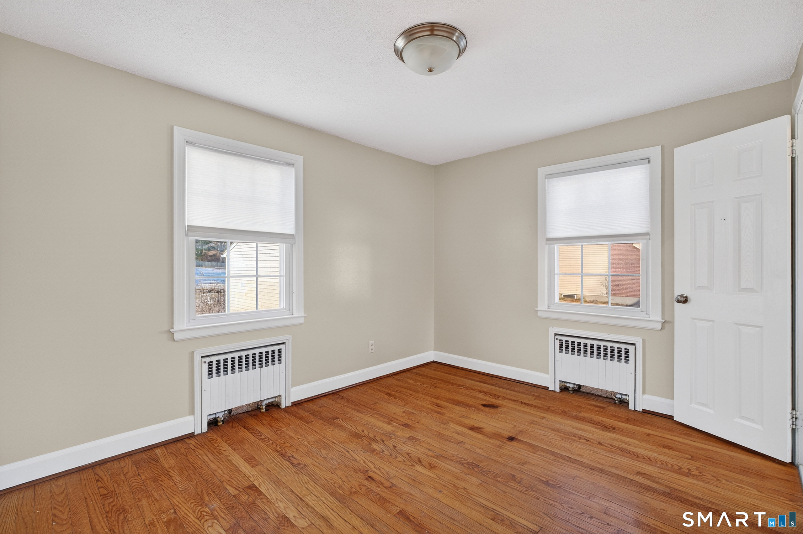 195 Middletown Avenue Wethersfield, CT 06109 - Photo 19 of 35 an empty room with wooden floor and windows