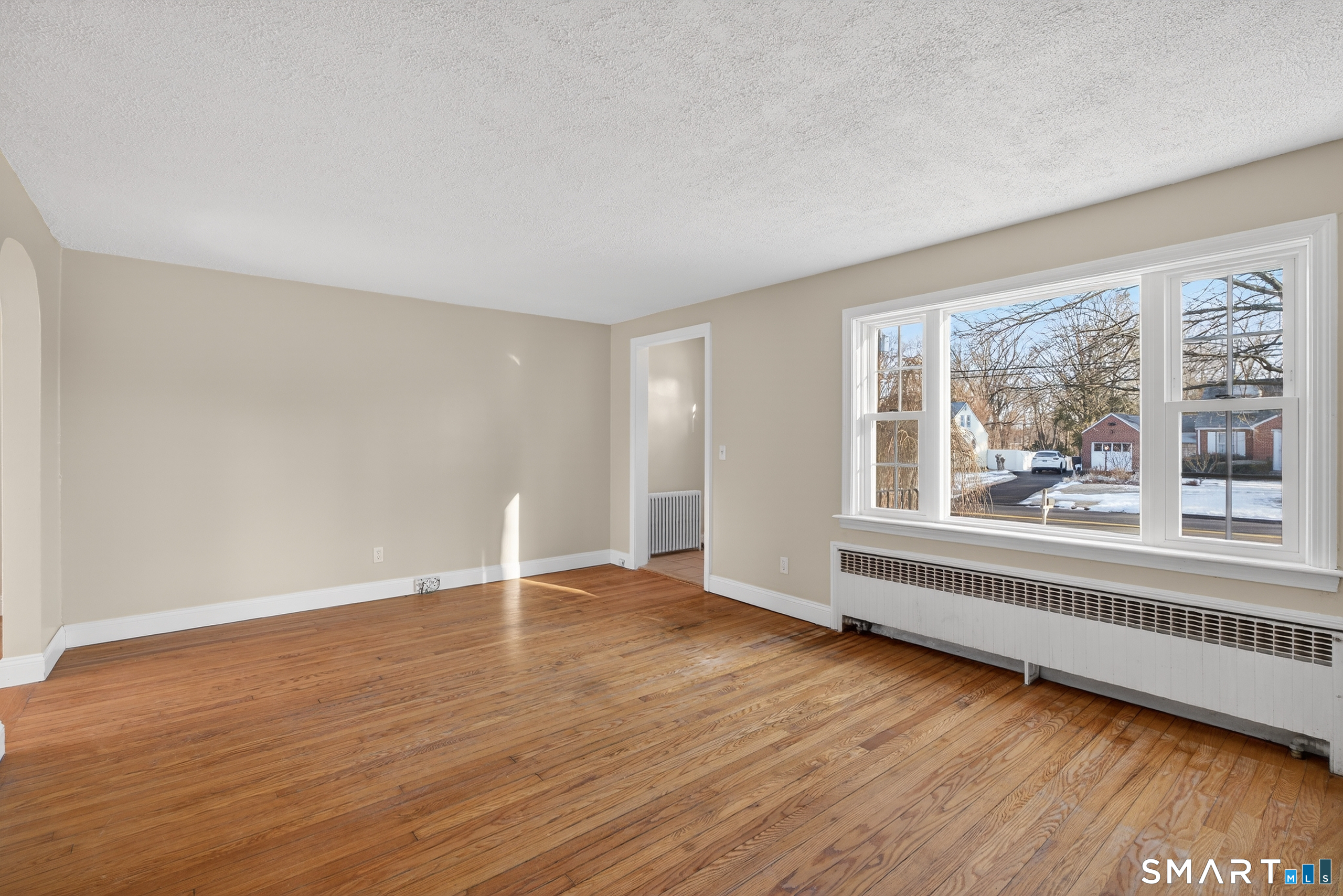 195 Middletown Avenue Wethersfield, CT 06109 - Photo 6 of 35 a view of an empty room with wooden floor and a window