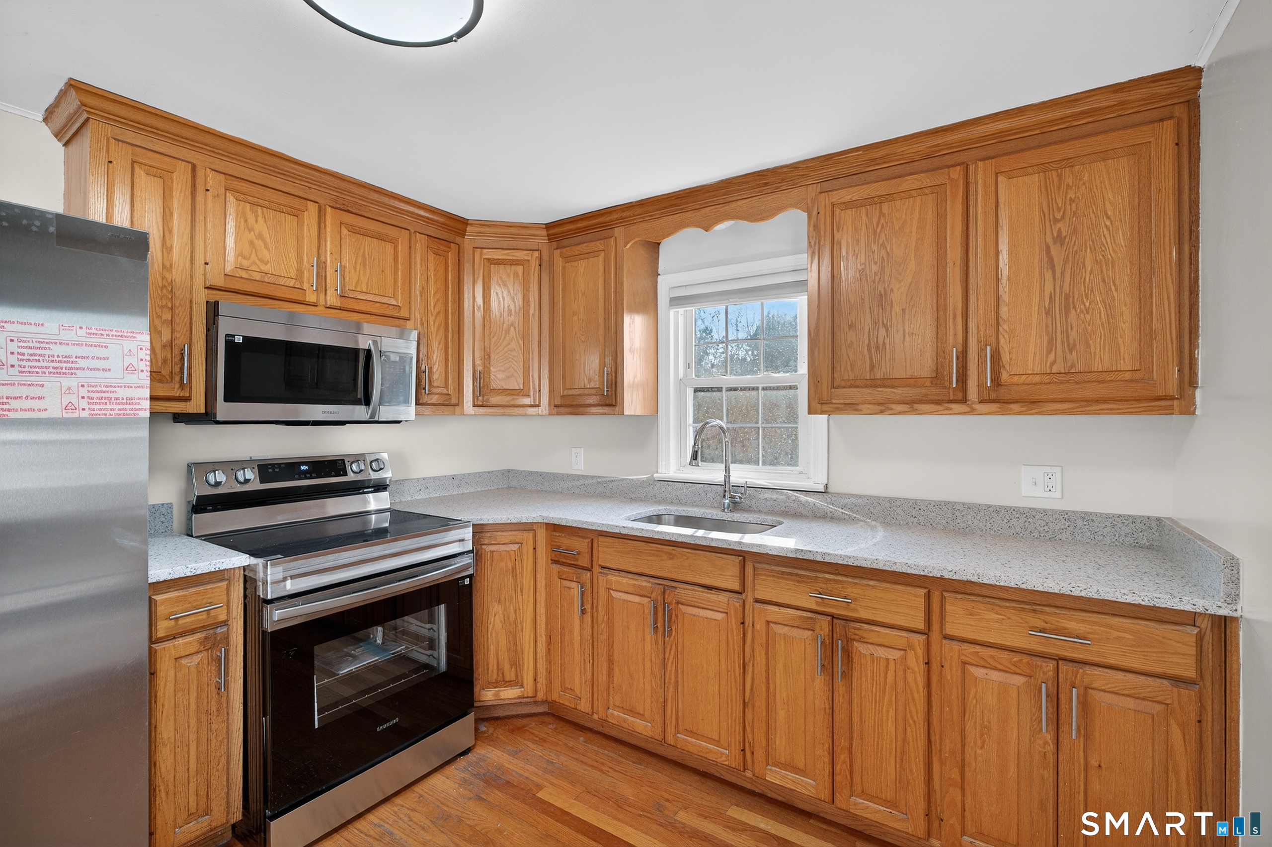 195 Middletown Avenue Wethersfield, CT 06109 - Photo 10 of 35 a kitchen with stainless steel appliances a stove microwave and sink
