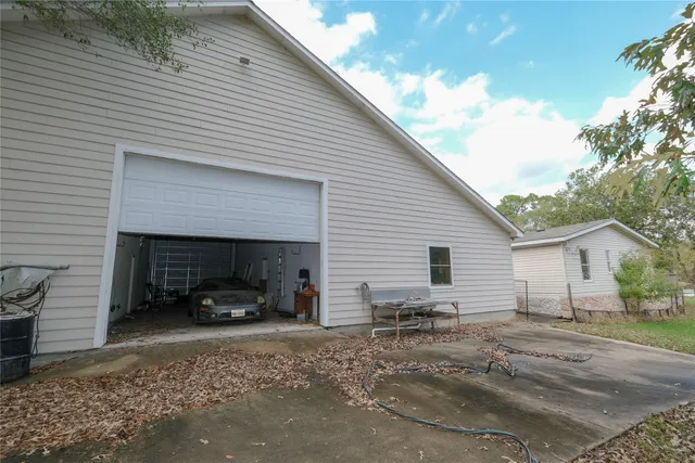 a view of a yard with large trees