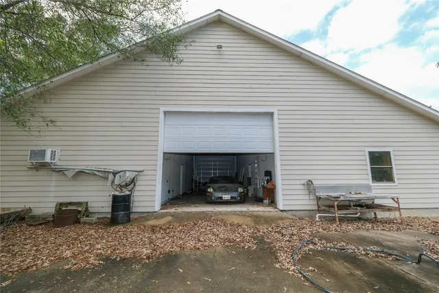 a view of a house with a yard and a garage