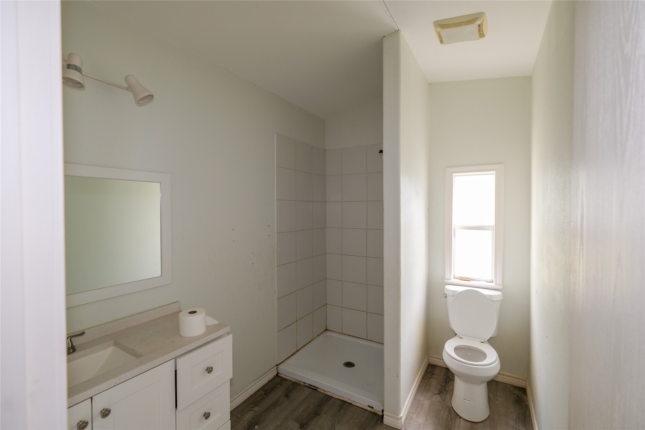 170 W Creek Trinity, TX 75862 - Photo 25 of 48 a bathroom with a granite countertop toilet a sink and a mirror