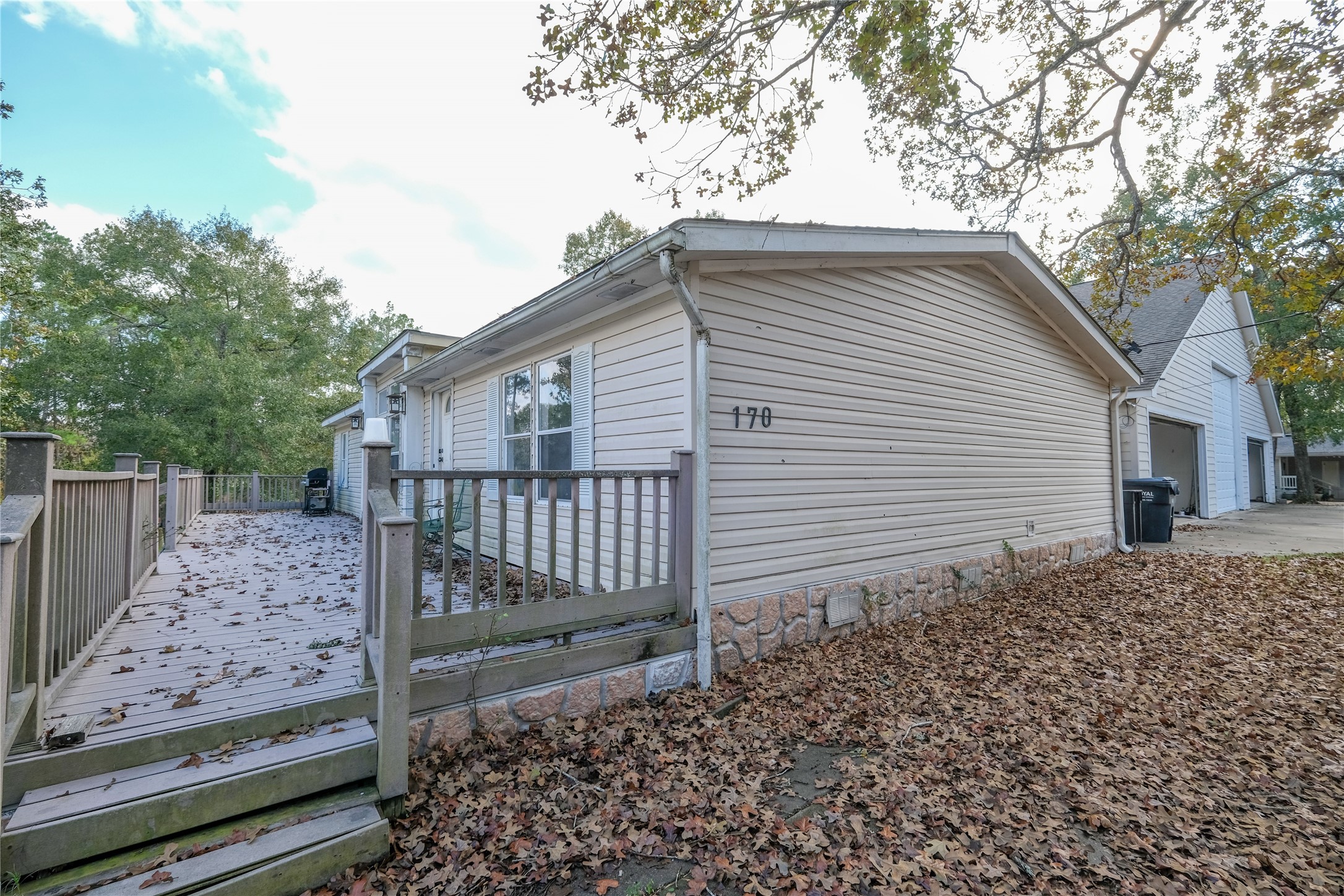 170 W Creek Trinity, TX 75862 - Photo 42 of 48 a view of a house with a small yard and large tree
