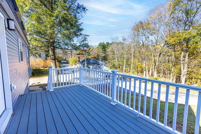 a view of a porch with wooden floor and fence