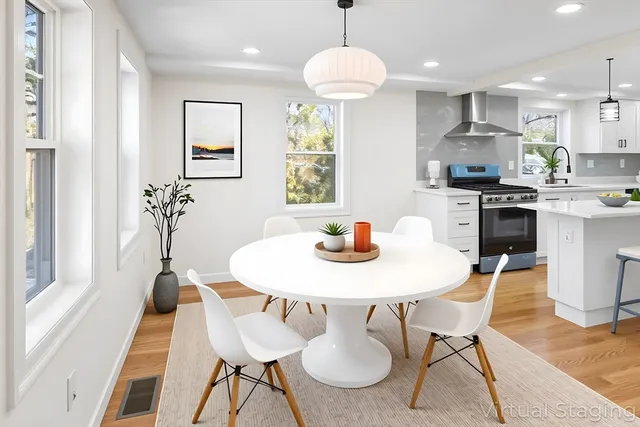 a view of a dining room with furniture window and wooden floor